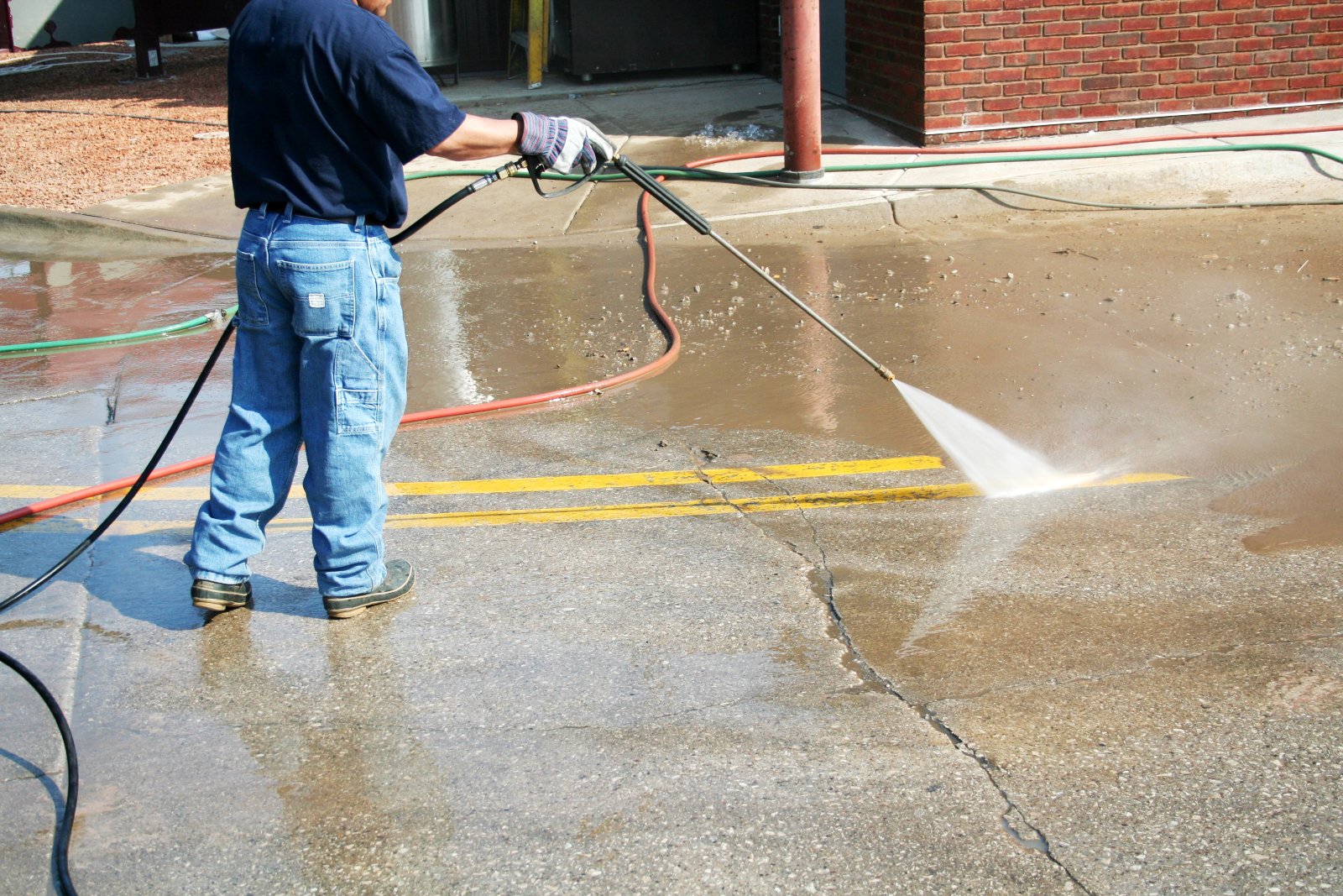 Pressure washing on concrete driveway