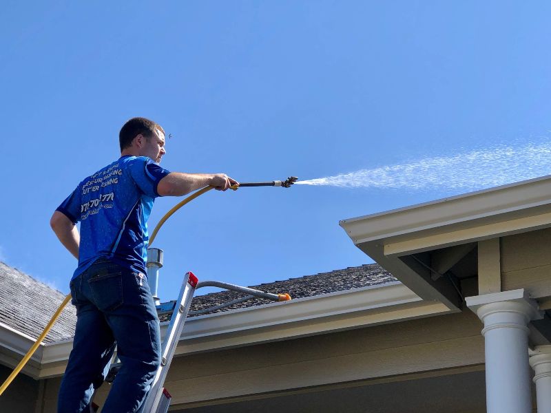 Technician doing gutter cleaning service